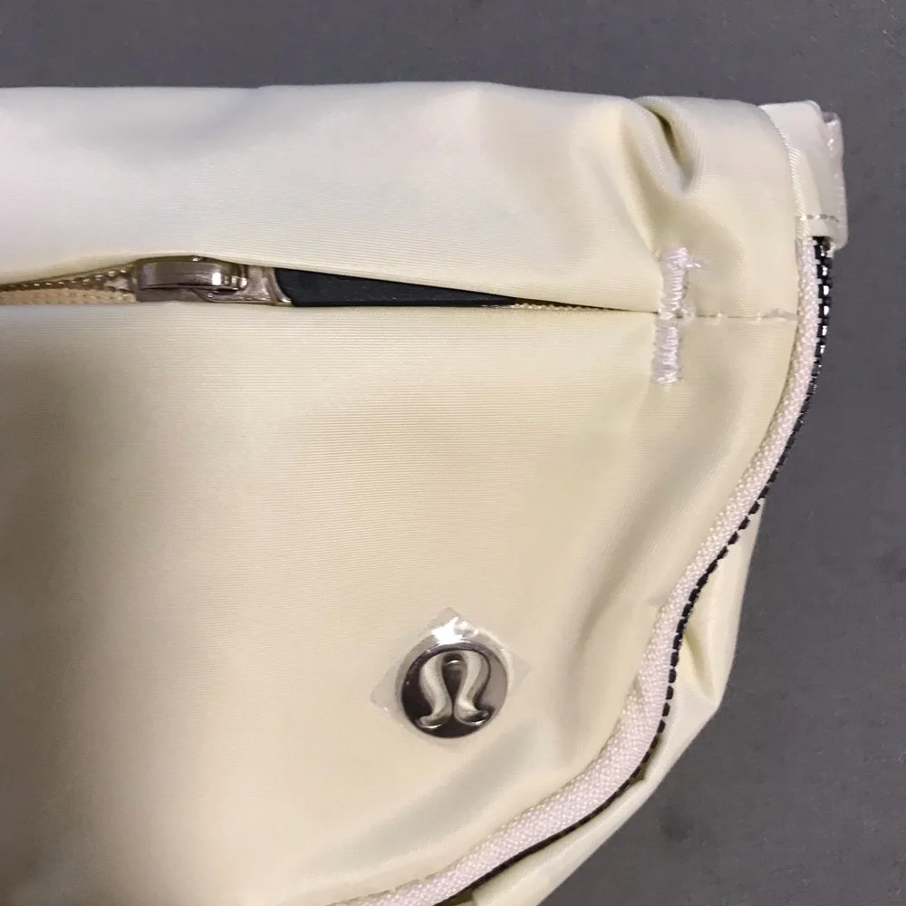 lululemon athletica cream fold-over wristlet with front zip 2L